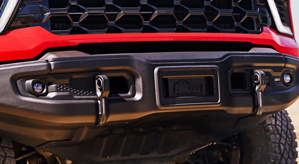 A close-up of the front bumper and grille of a red 2024 Chevy Silverado HD ZR2 Bison.
