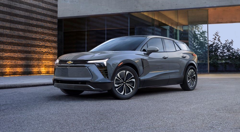 A grey 2025 Chevy Blazer EV LT parked outside a building.
