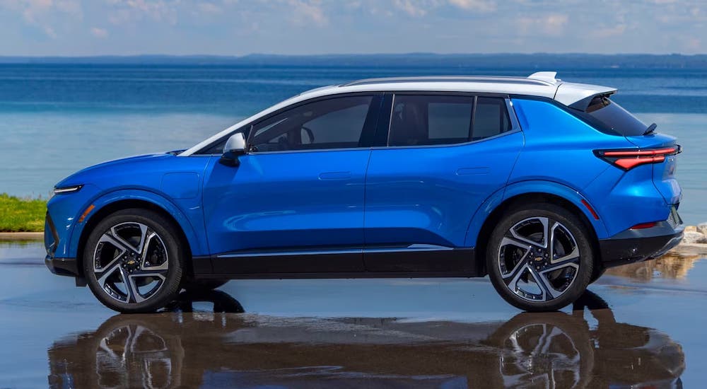 Side angle view of a blue 2025 Chevy Equinox EV parked on a lot after visiting a Chevy dealer near Taylor.