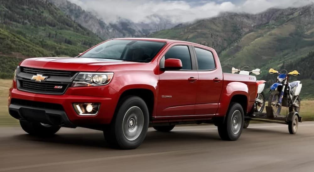 A red 2020 Chevy Colorado driving on a highway.