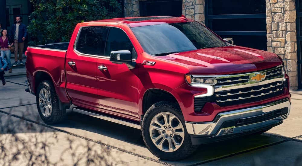 A red 2024 Chevy Silverado 1500 Z71 parked on a driveway.