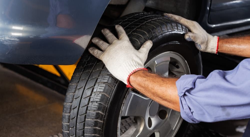 A technician inspecting a tire.