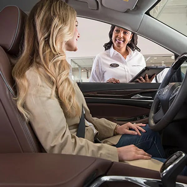 service woman and woman sitting car