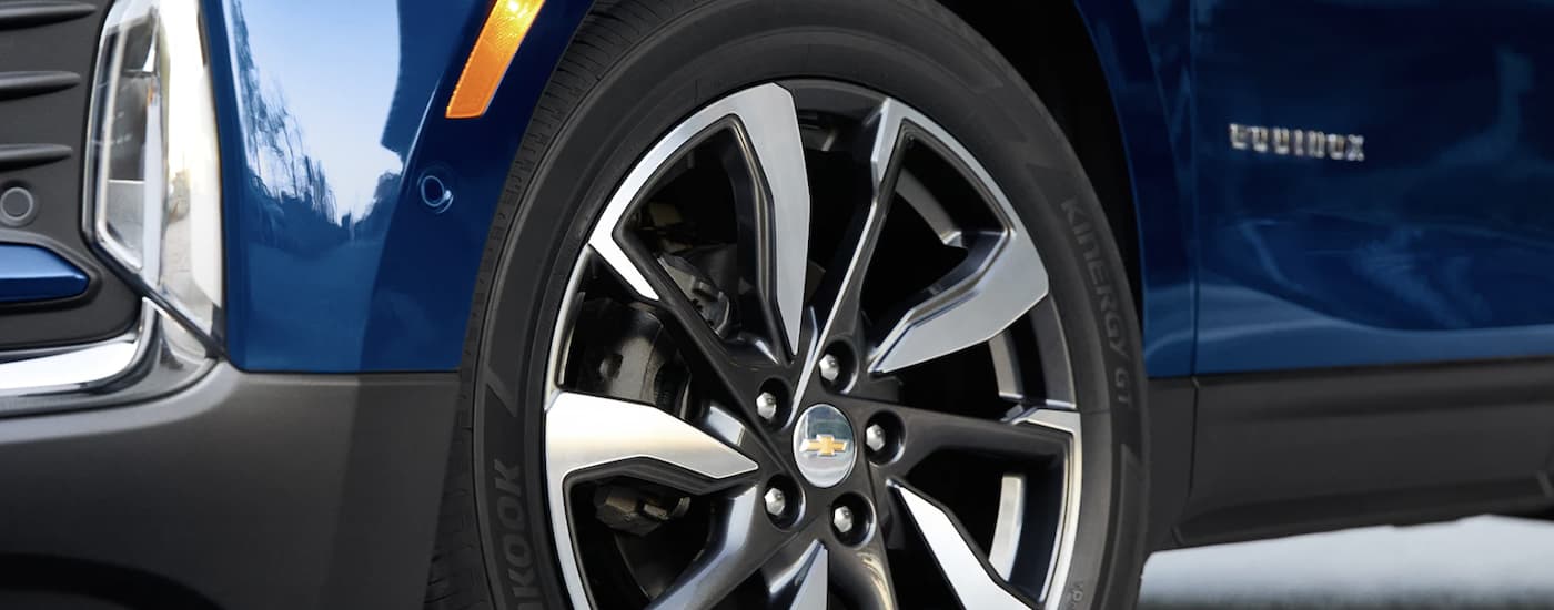 Rim and tire on a blue 2022 Chevy Equinox LS