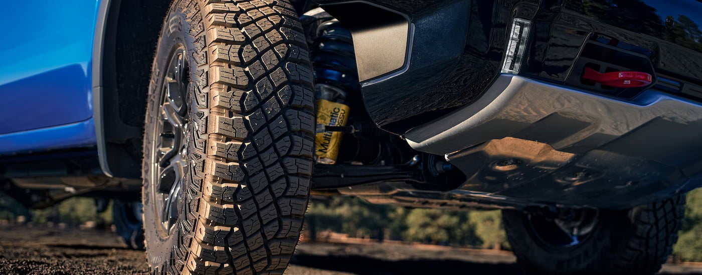 Close-up on the rear wheels of a blue 2025 Chevy Silverado 1500.