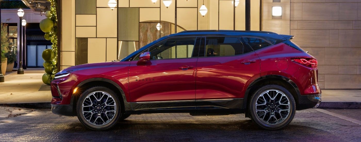 A red 2023 Chevy Blazer RS is shown in front of a modern building.