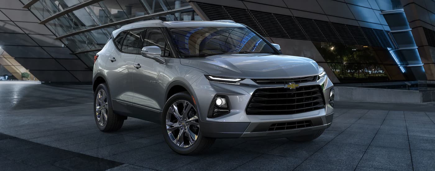 Rear of a dark blue 2022 Chevy Equinox driving by a lake.