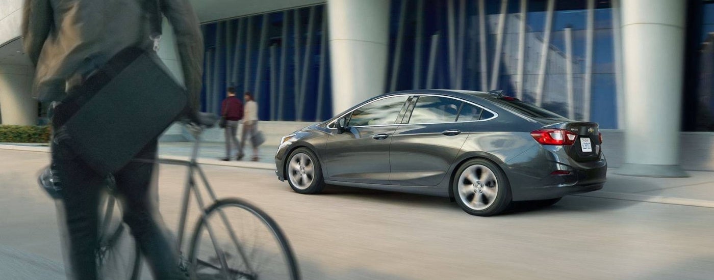 A grey 2017 Chevy Cruze is shown driving to a used Chevy dealer near Livonia.