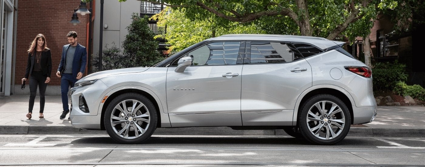 A silver 2020 Chevy Blazer is shown from the side on a city street.