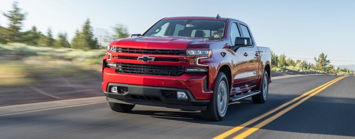 Red used 2020 Chevy Silverado 1500 Z71 for sale driving down an open road.