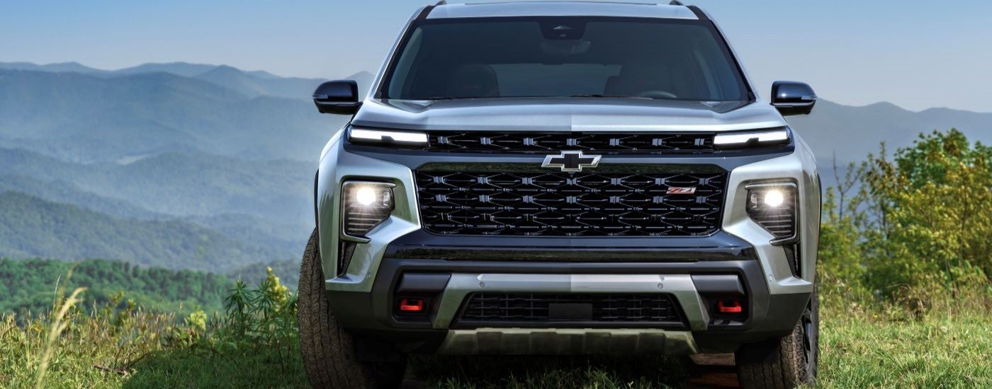 Front grille on a silver 2025 Chevy Traverse Z71 parked off-road